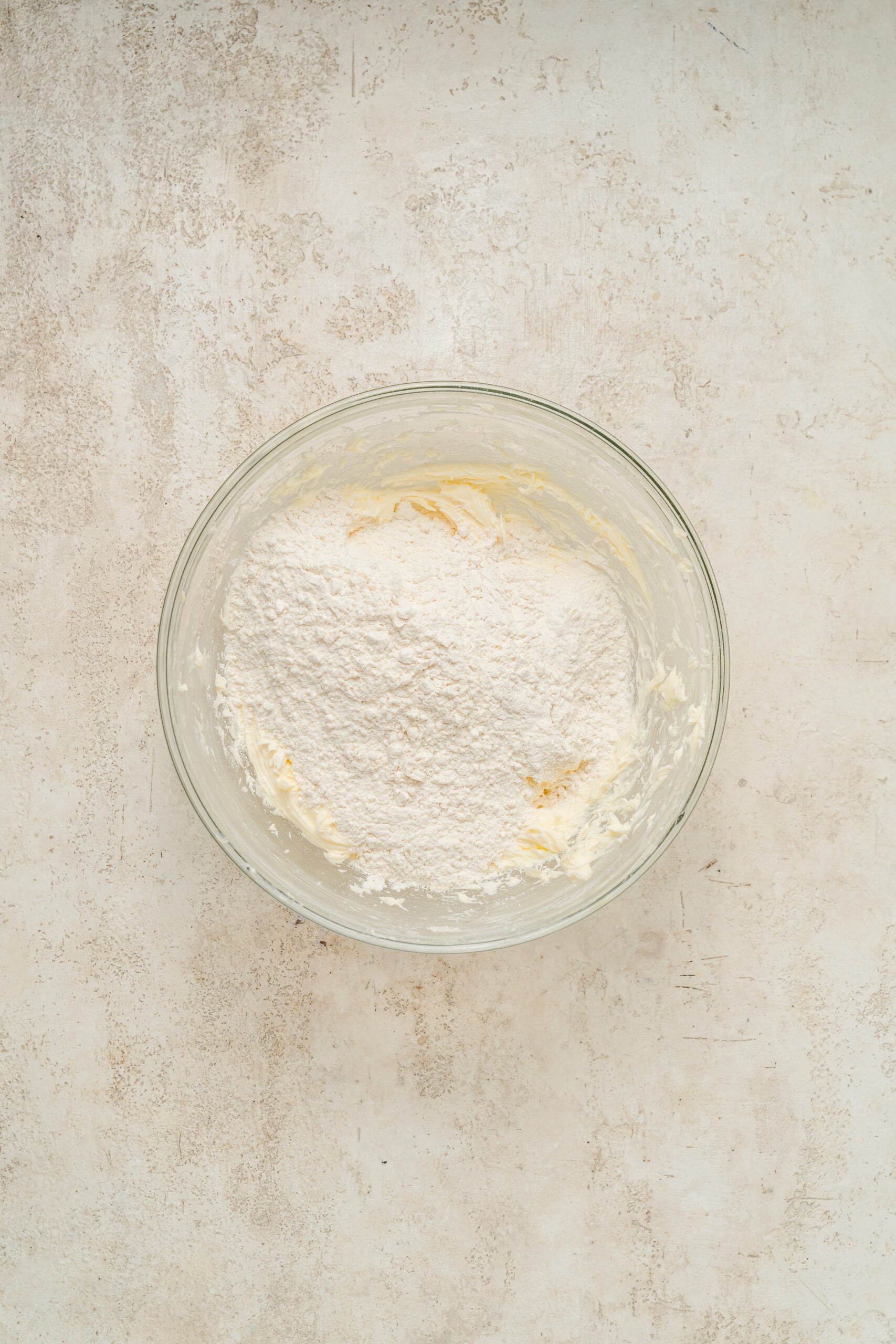 Flour added on top of the creamed butter for snowball cookie dough - Catherine Zhang Flour added on top of the creamed butter for snowball cookie dough