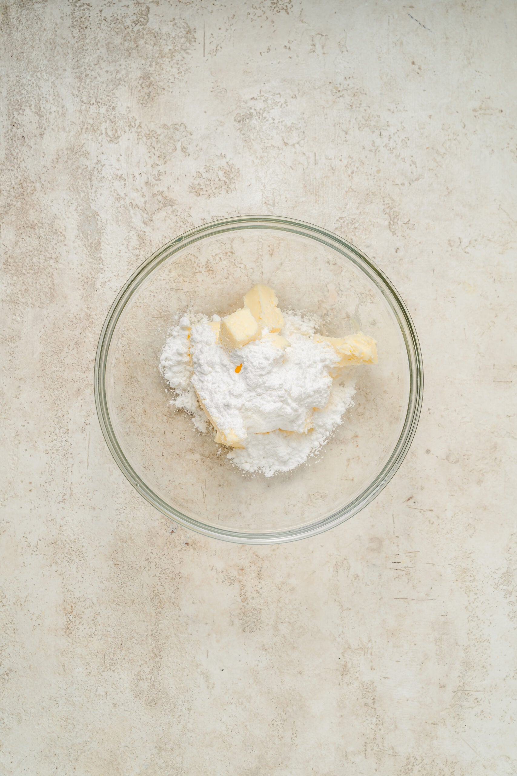 Softened butter and powdered sugar in a glass bowl before creaming - Catherine Zhang Softened butter and powdered sugar in a glass bowl before creaming