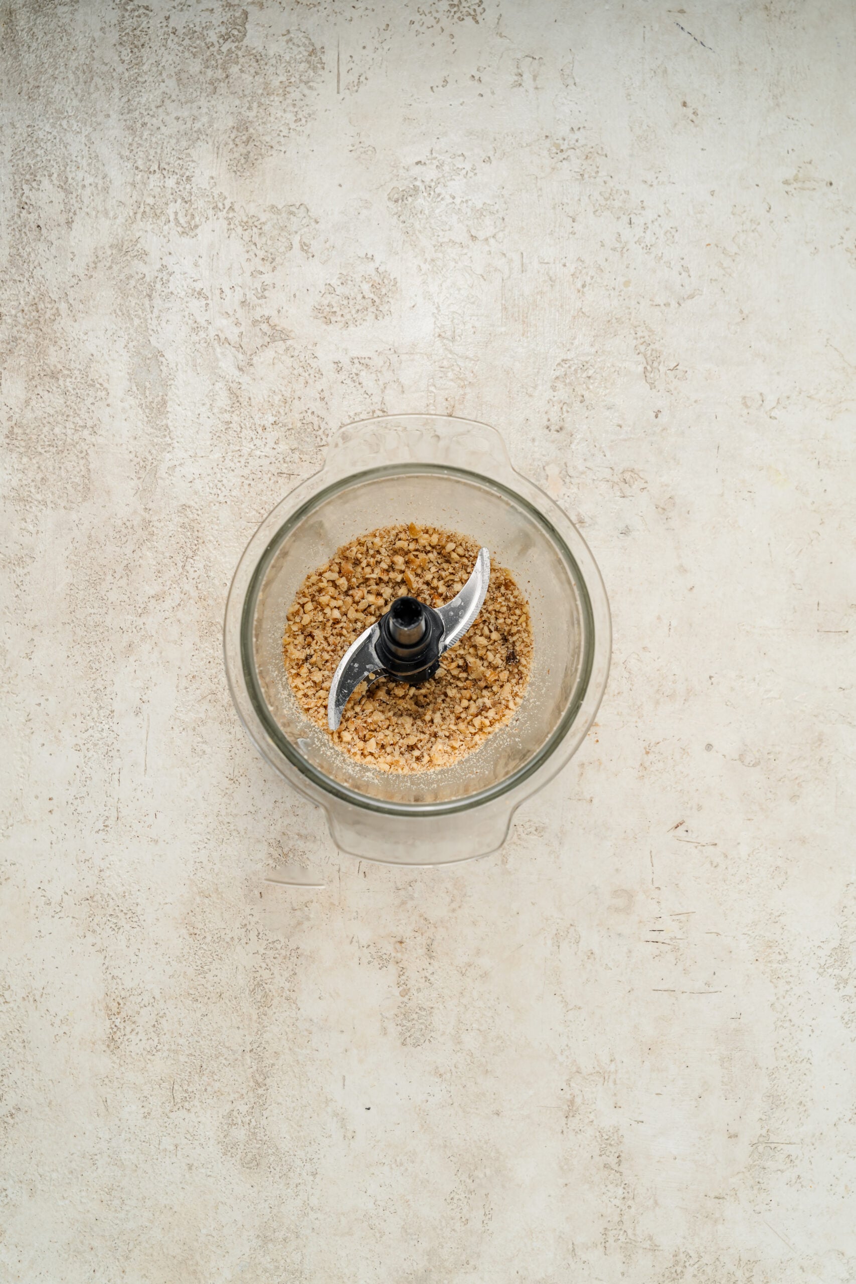 Toasted pecans pulsed to coarse sand in a food processor - Catherine Zhang Toasted pecans pulsed to coarse sand in a food processor