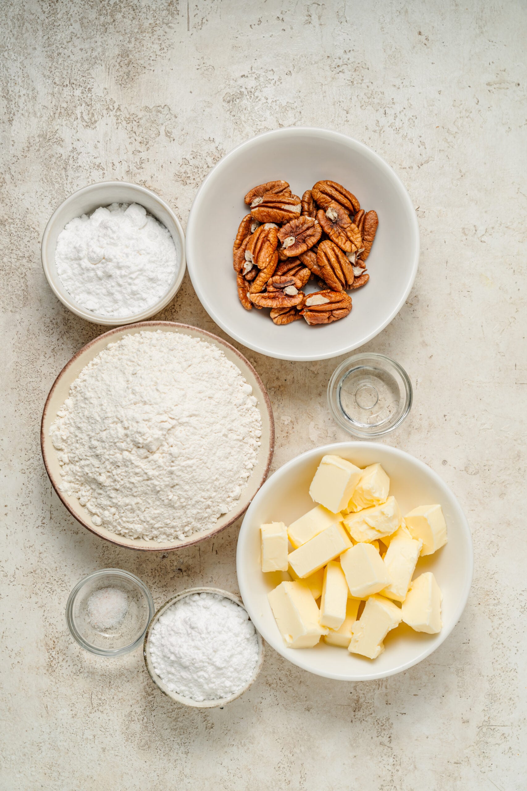 Ingredients for snowball cookies, pecans, butter, powdered sugar, flour, vanilla and salt - Catherine Zhang Ingredients for snowball cookies, pecans, butter, powdered sugar, flour, vanilla and salt
